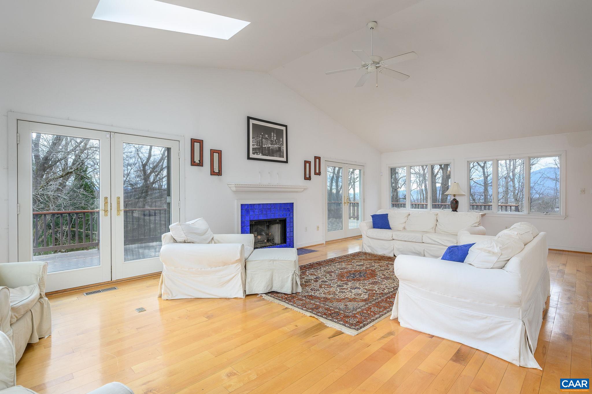 9165 Dick Woods Road Afton, VA 22920 - Photo 5 of 56 a living room with furniture large window and a fireplace