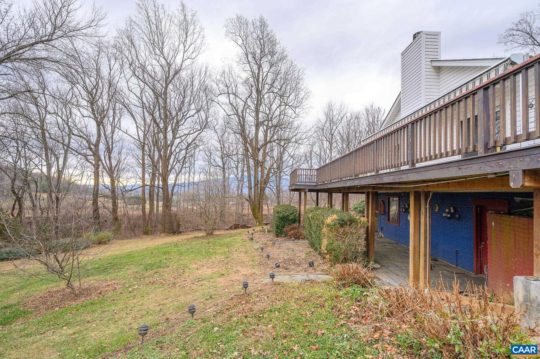9165 Dick Woods Road Afton, VA 22920 - Photo 52 of 56 a backyard of a house with large trees and wooden fence