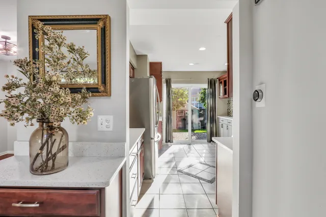 a bathroom with a granite countertop sink a mirror and shower