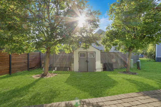 a view of a house with backyard and sitting area