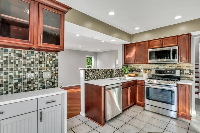 a kitchen with stainless steel appliances granite countertop a stove and a microwave