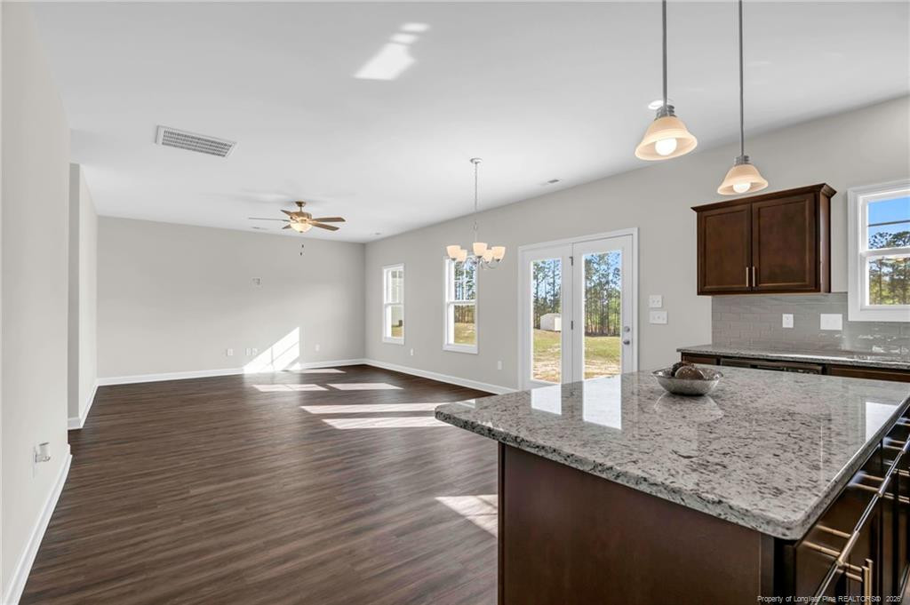 64 Onslow Court Spring Lake, NC 28390 - Photo 11 of 37 a kitchen with granite countertop stove top oven and refrigerator
