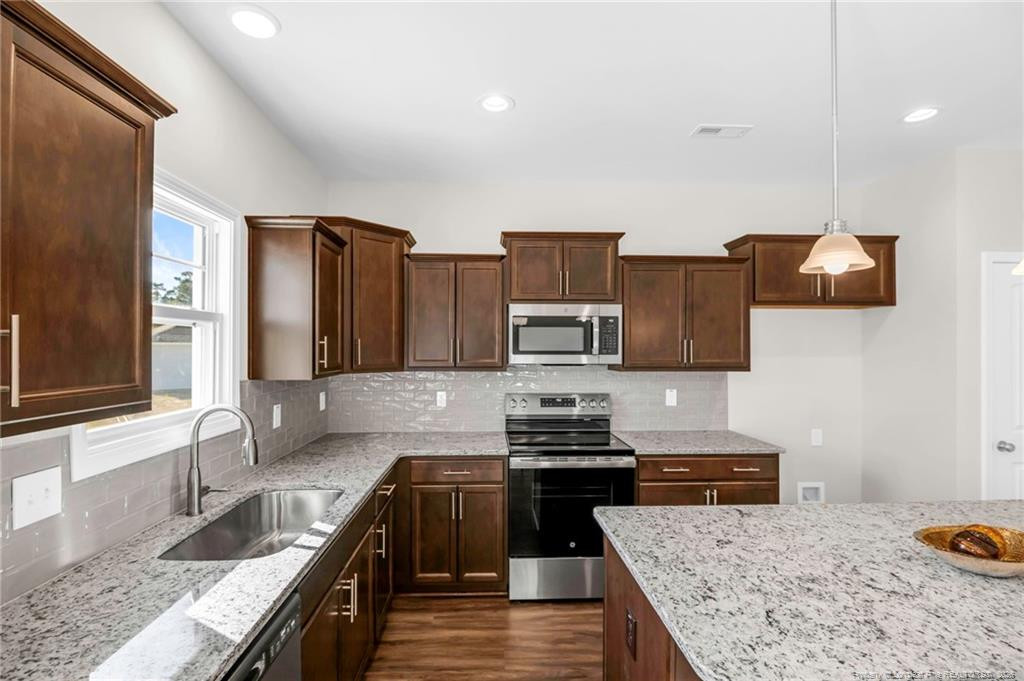64 Onslow Court Spring Lake, NC 28390 - Photo 13 of 37 a kitchen with stainless steel appliances granite countertop a sink stove and refrigerator