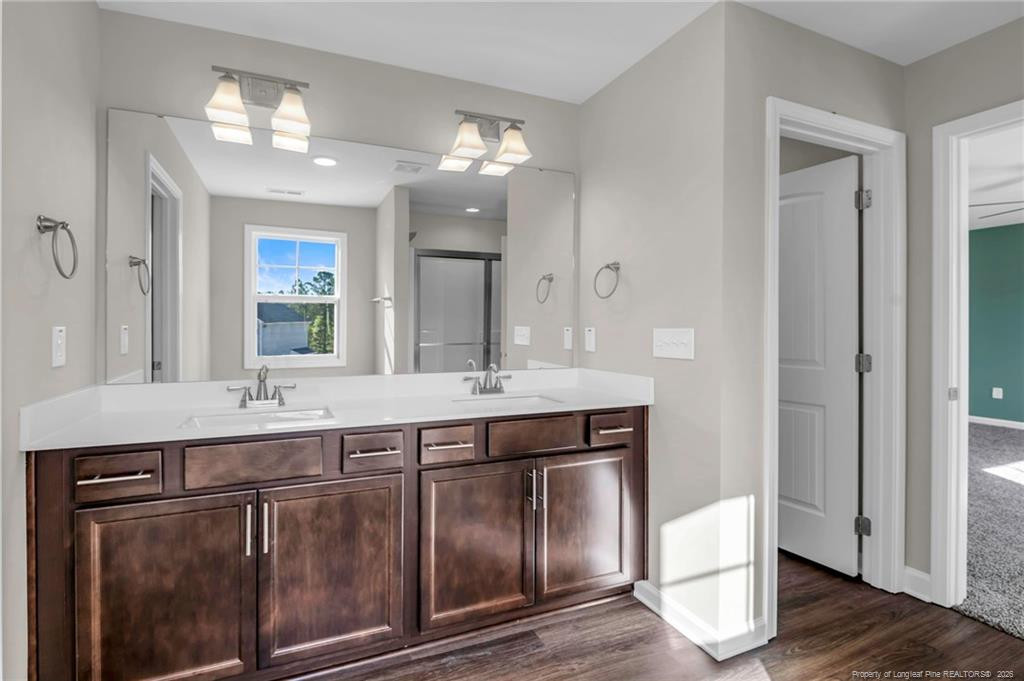 64 Onslow Court Spring Lake, NC 28390 - Photo 19 of 37 a bathroom with a granite countertop sink and a mirror