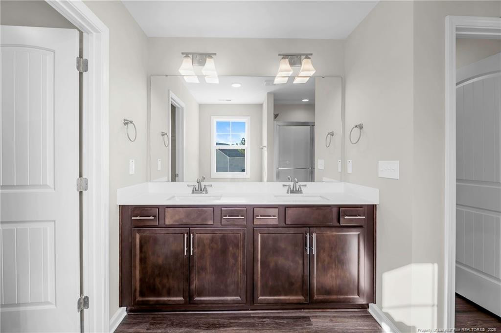 64 Onslow Court Spring Lake, NC 28390 - Photo 20 of 37 a spacious bathroom with a sink and a mirror
