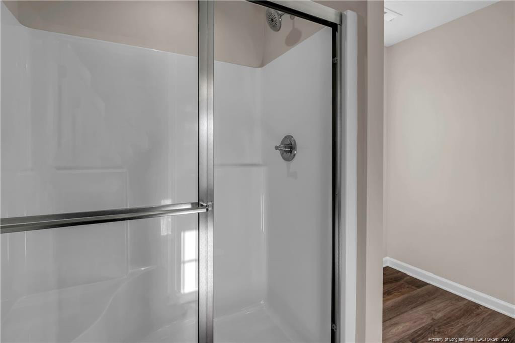 64 Onslow Court Spring Lake, NC 28390 - Photo 22 of 37 a bathroom with a glass shower door