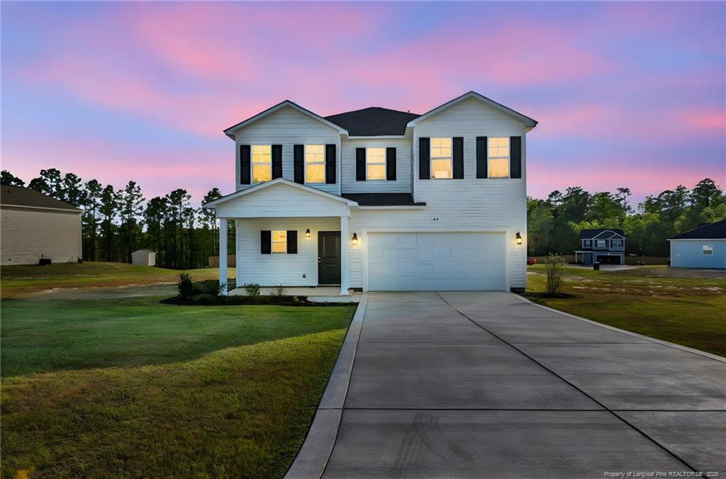 64 Onslow Court Spring Lake, NC 28390 - Photo 3 of 37 a front view of a house with a garden and yard