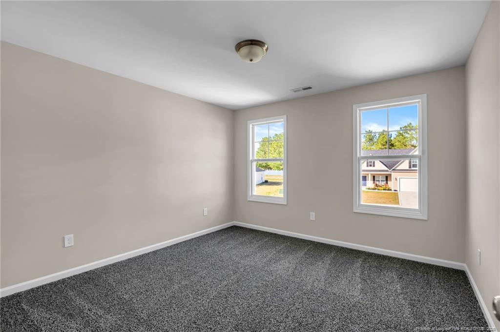 64 Onslow Court Spring Lake, NC 28390 - Photo 31 of 37 an empty room with windows