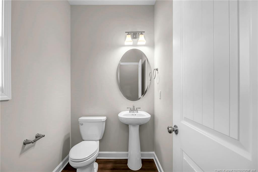 64 Onslow Court Spring Lake, NC 28390 - Photo 6 of 37 a bathroom with a toilet sink and mirror