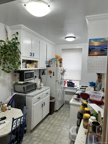 a kitchen that has a lot of cabinets a sink and a stove in it