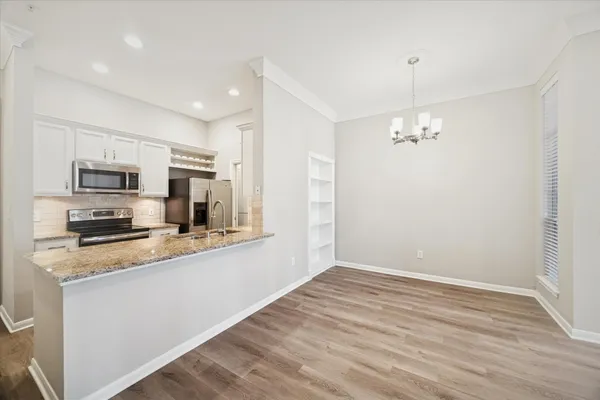 a kitchen with stainless steel appliances a refrigerator sink and microwave