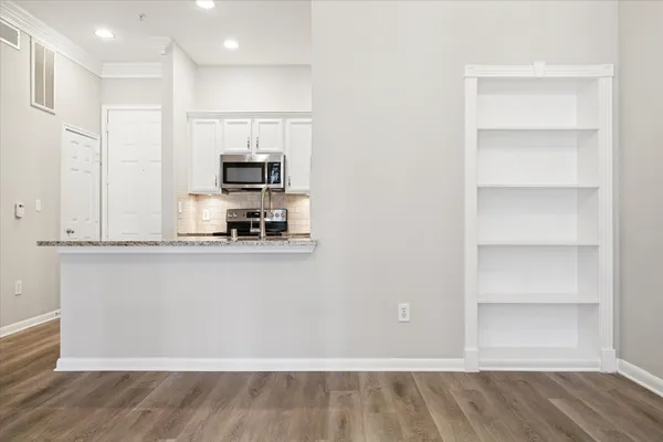 a view of a kitchen with a sink and a refrigerator