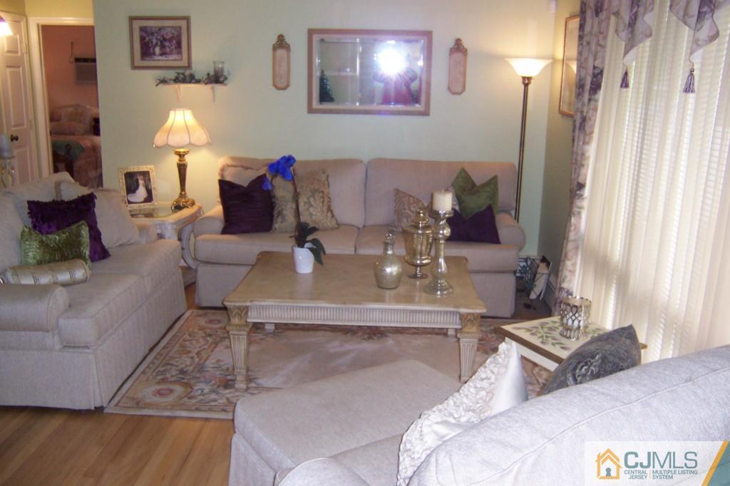 35 Hillcrest Road Colonia, NJ 07067 - Photo 2 of 17 a living room with furniture and a lamp