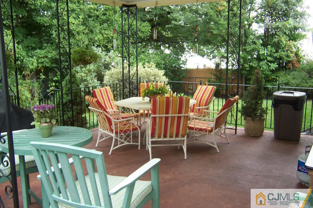 35 Hillcrest Road Colonia, NJ 07067 - Photo 14 of 17 a view of an chairs and tables in the back yard