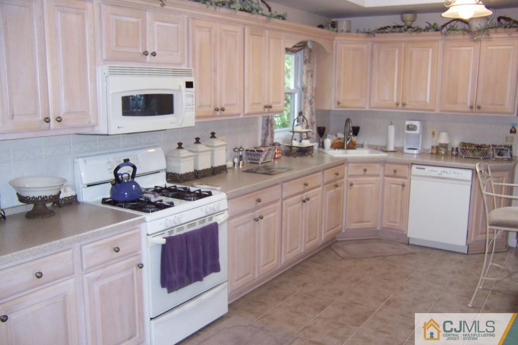 35 Hillcrest Road Colonia, NJ 07067 - Photo 6 of 17 a kitchen with cabinets appliances a sink and a counter top