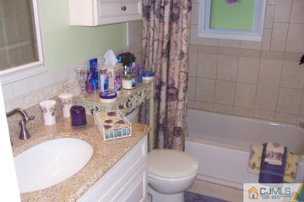 35 Hillcrest Road Colonia, NJ 07067 - Photo 10 of 17 a bathroom with a granite countertop sink a toilet and shower