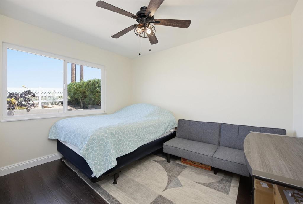 421 Hillcrest Lane Fallbrook, CA 92028 - Photo 13 of 32 a bedroom with a bed couch and window