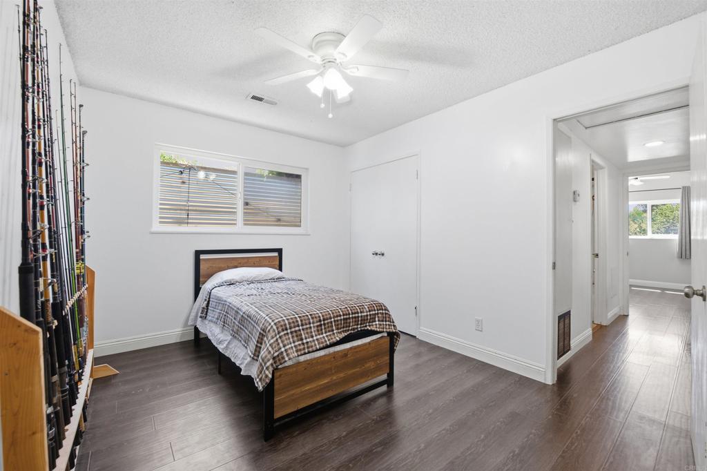 421 Hillcrest Lane Fallbrook, CA 92028 - Photo 15 of 32 a bedroom with a bed and a chandelier