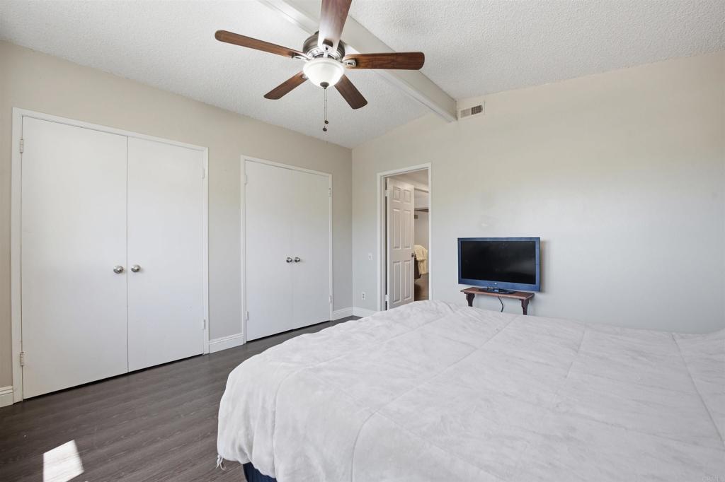 421 Hillcrest Lane Fallbrook, CA 92028 - Photo 19 of 32 a spacious bedroom with a bed and a flat screen tv
