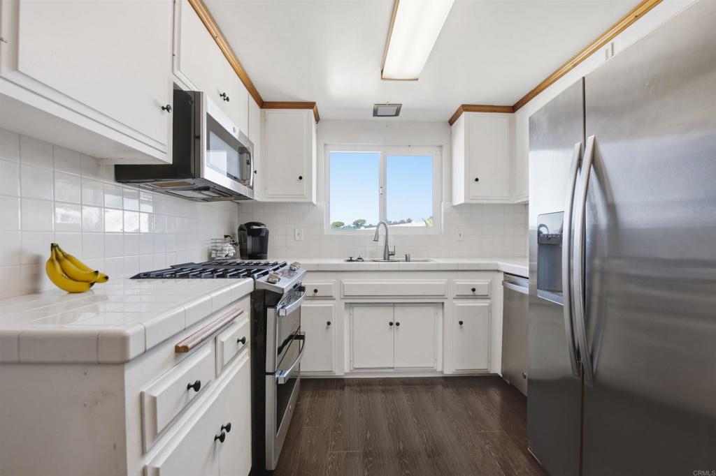 421 Hillcrest Lane Fallbrook, CA 92028 - Photo 7 of 32 a kitchen with stainless steel appliances granite countertop a sink stove and refrigerator