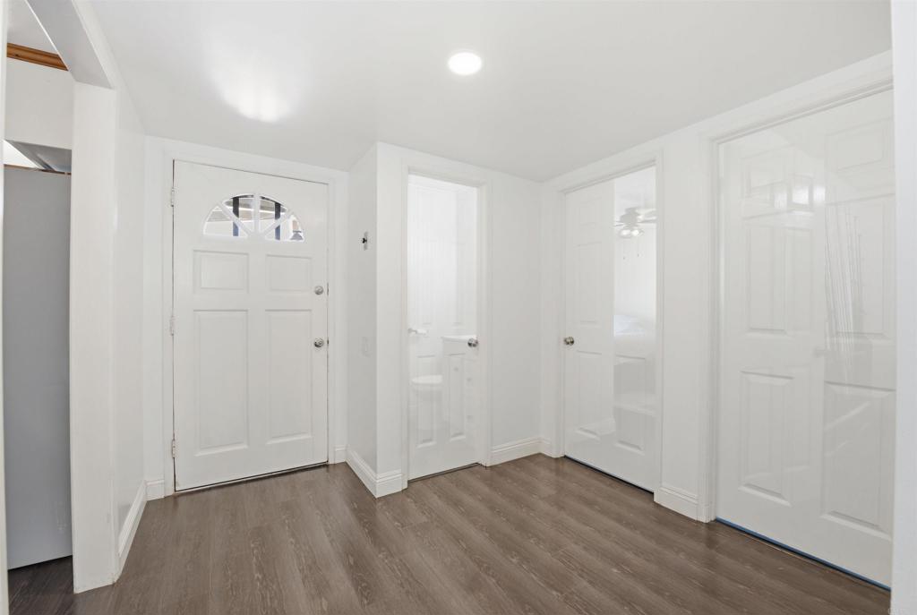 421 Hillcrest Lane Fallbrook, CA 92028 - Photo 9 of 32 an empty room with wooden floor and windows