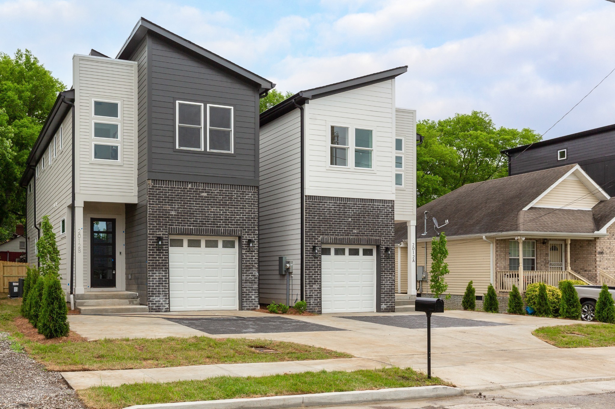 2012 Owen Street, Unit A Nashville, TN 37208 - Photo 3 of 32 a front view of a house with a yard and garage