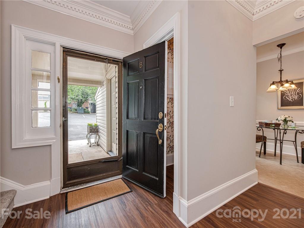 5939 Quail Hollow Road, Unit B Charlotte, NC 28210 - Photo 2 of 23 a view of a hallway with wooden floor and windows