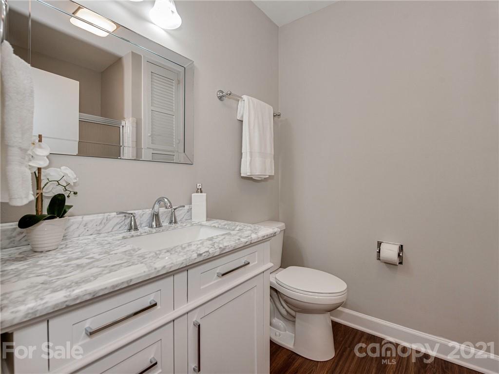 5939 Quail Hollow Road, Unit B Charlotte, NC 28210 - Photo 15 of 23 a bathroom with a granite countertop sink a toilet and a mirror