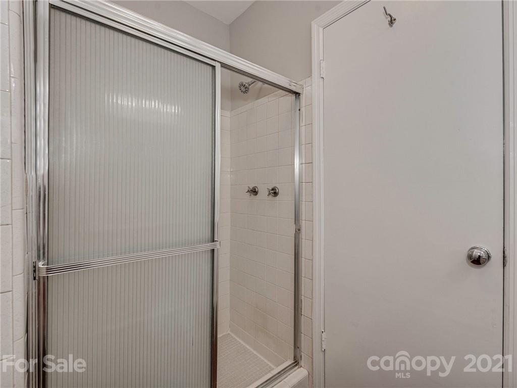 5939 Quail Hollow Road, Unit B Charlotte, NC 28210 - Photo 16 of 23 a bathroom with a glass shower door