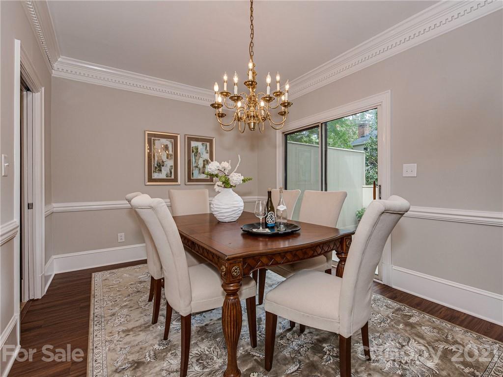 5939 Quail Hollow Road, Unit B Charlotte, NC 28210 - Photo 6 of 23 a view of a dining room with furniture a chandelier and wooden floor