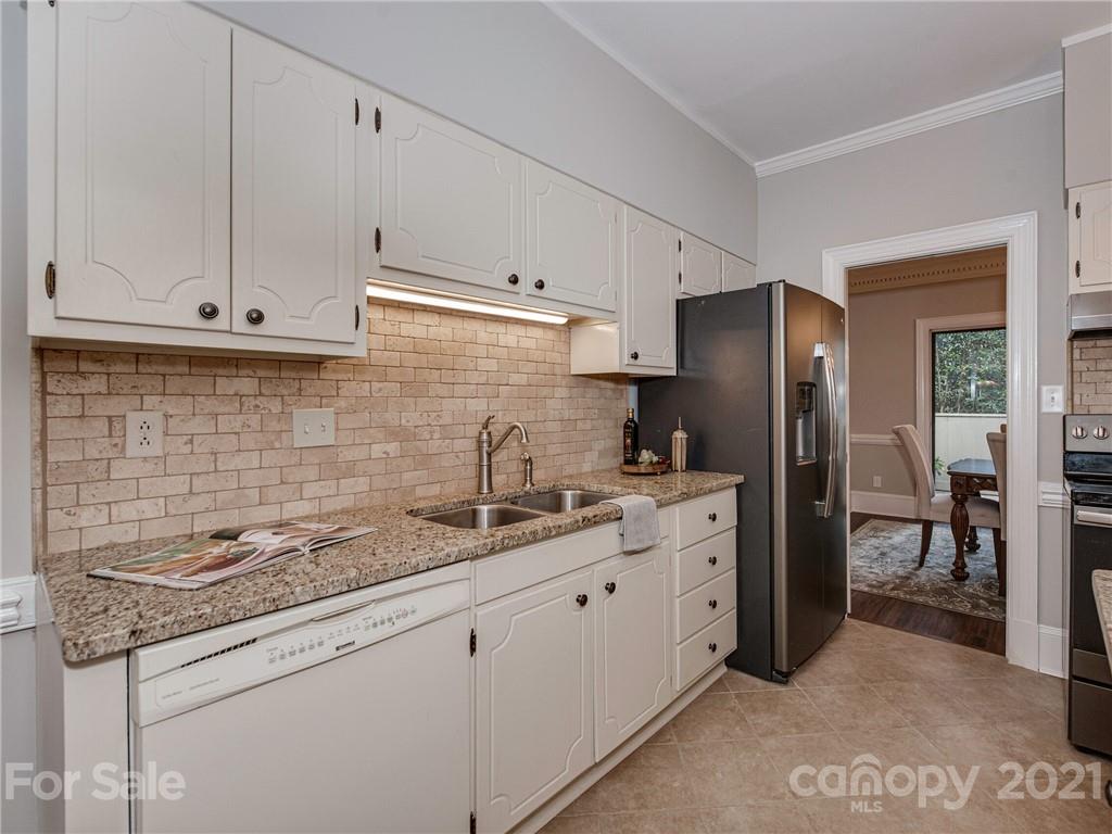 5939 Quail Hollow Road, Unit B Charlotte, NC 28210 - Photo 8 of 23 a kitchen with stainless steel appliances granite countertop a sink stove and refrigerator