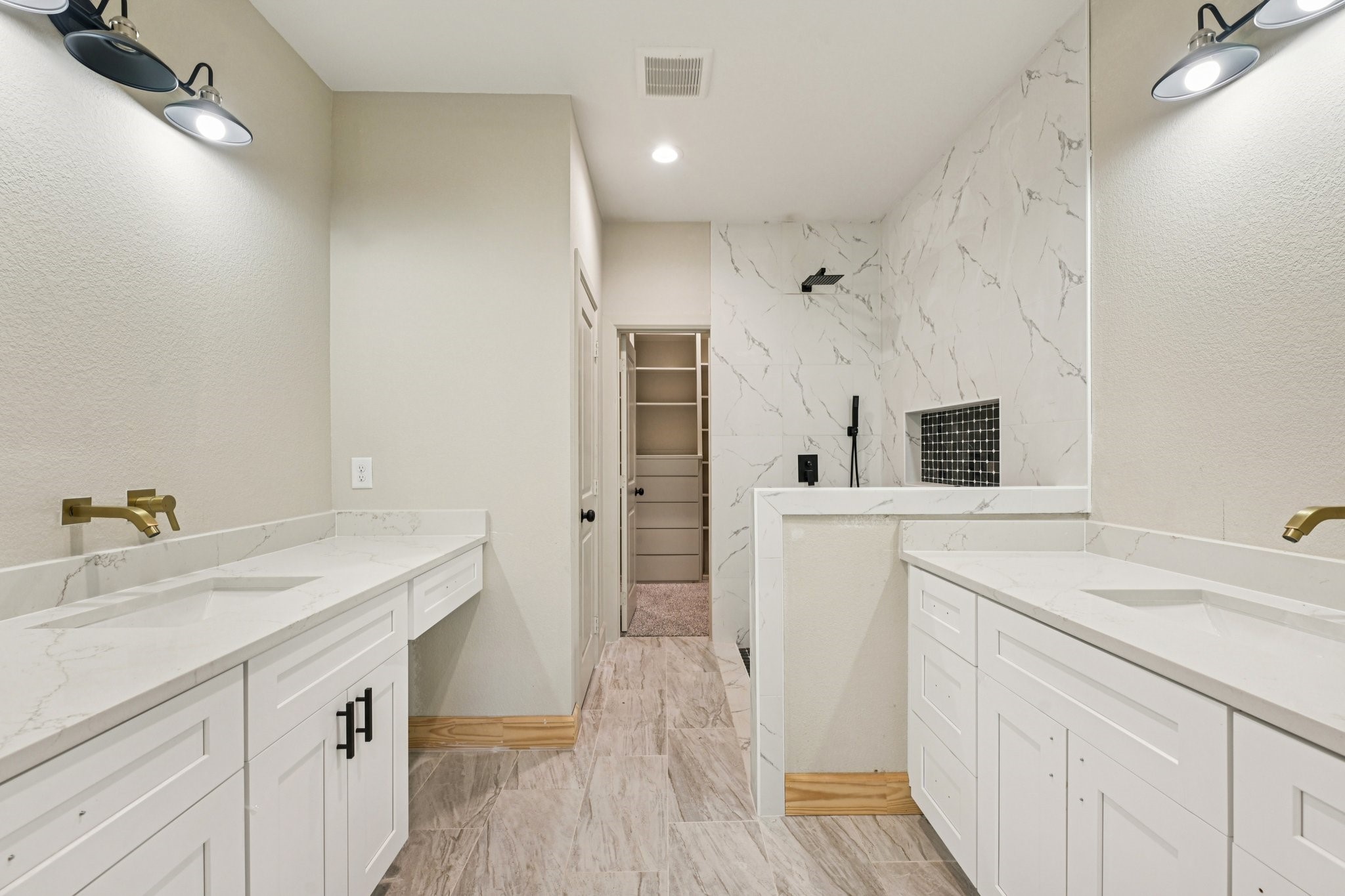 15132 Coaltown Road Willis, TX 77378 - Photo 24 of 29 This modern bathroom features dual sinks with white cabinetry and Quartz countertops. It has a spacious walk-in shower with elegant tile work and a built-in shelf.
