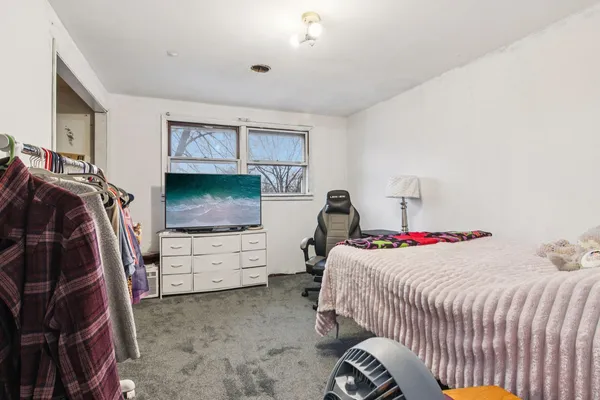 a room with furniture a flat screen tv and a window