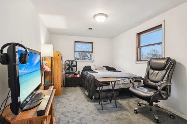 a bedroom with furniture and a window