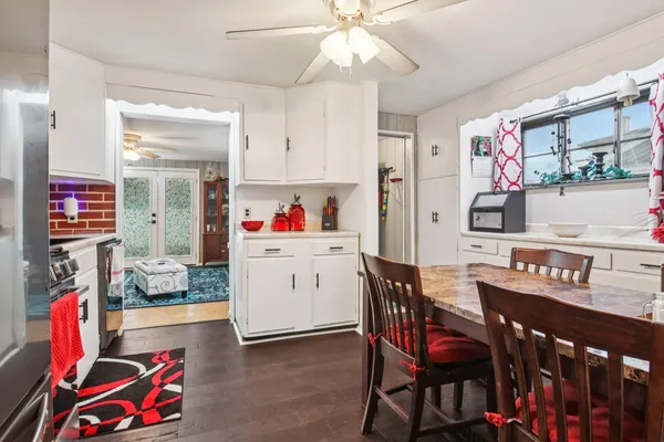 a dining room with furniture and wooden floor