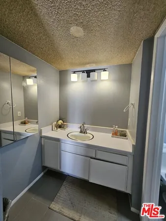 a bathroom with a sink and mirror