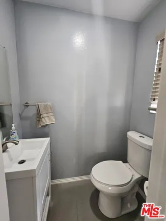 a white toilet sitting next to a bathroom sink