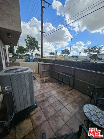 a view of a terrace with couches and wooden floor