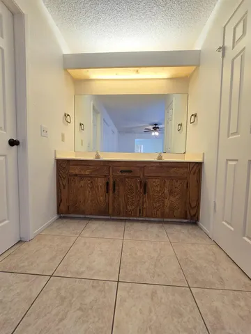 a bathroom with a vanity and mirror