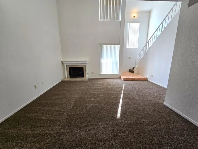 a view of a livingroom with an empty space and a fireplace
