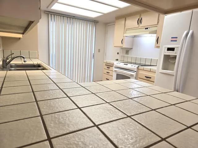 a kitchen with stainless steel appliances a refrigerator sink and cabinets