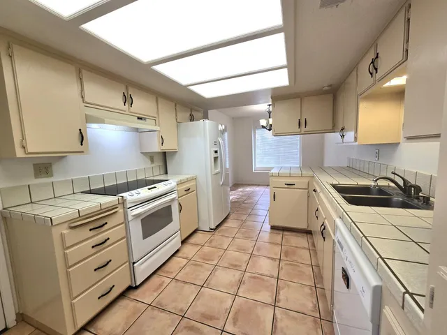 a kitchen with a stove sink and cabinets