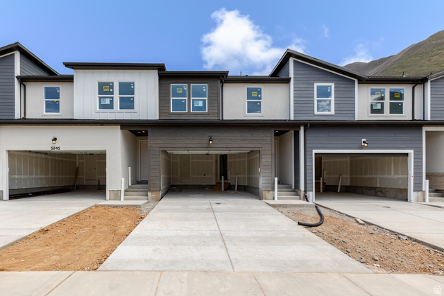 View of front of property featuring an attached garage and driveway
