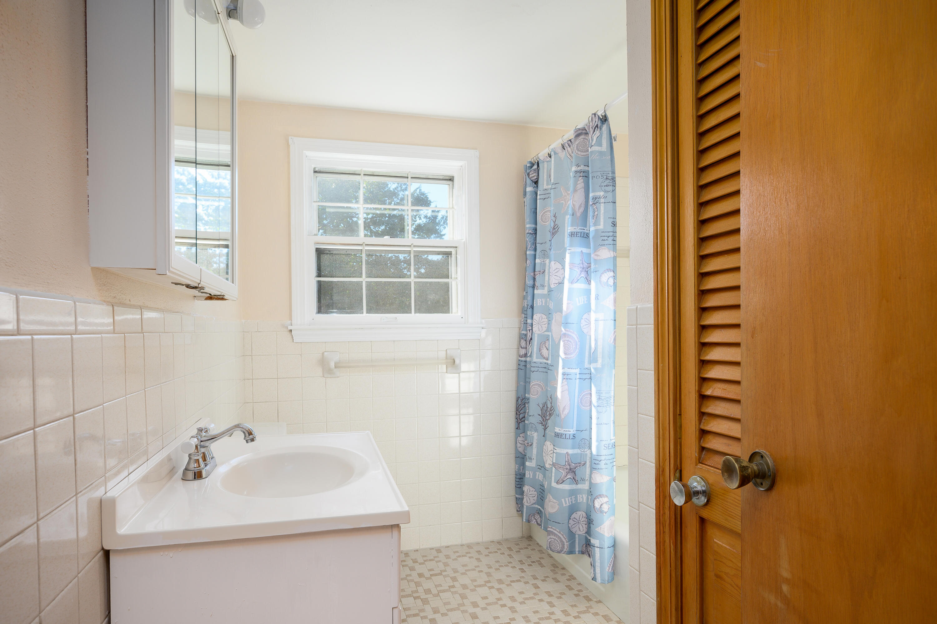 906 Shore Road Pocasset, MA 02559 - Photo 15 of 38 a bathroom with a sink and a mirror