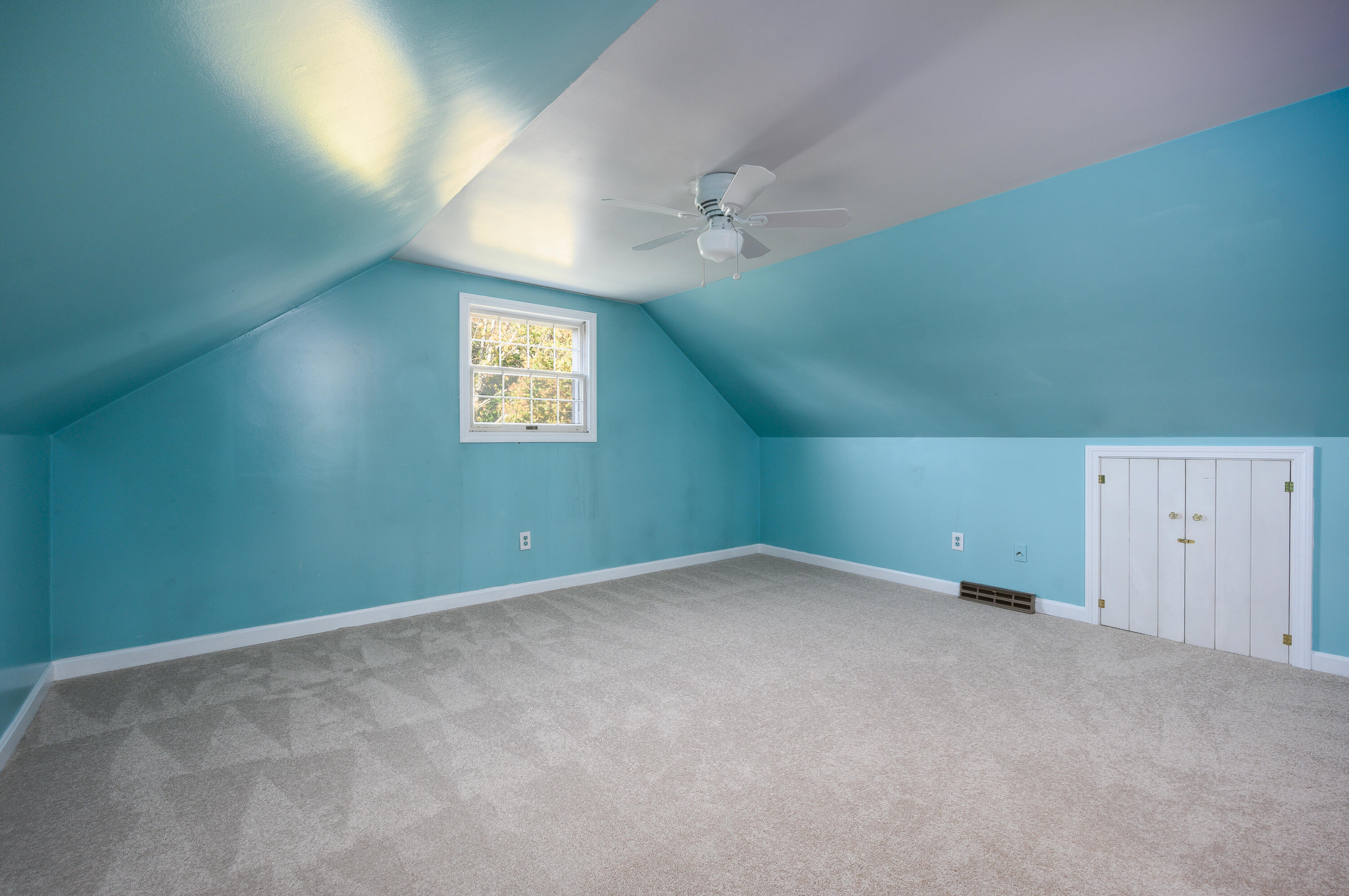 906 Shore Road Pocasset, MA 02559 - Photo 19 of 38 an empty room with windows and fan