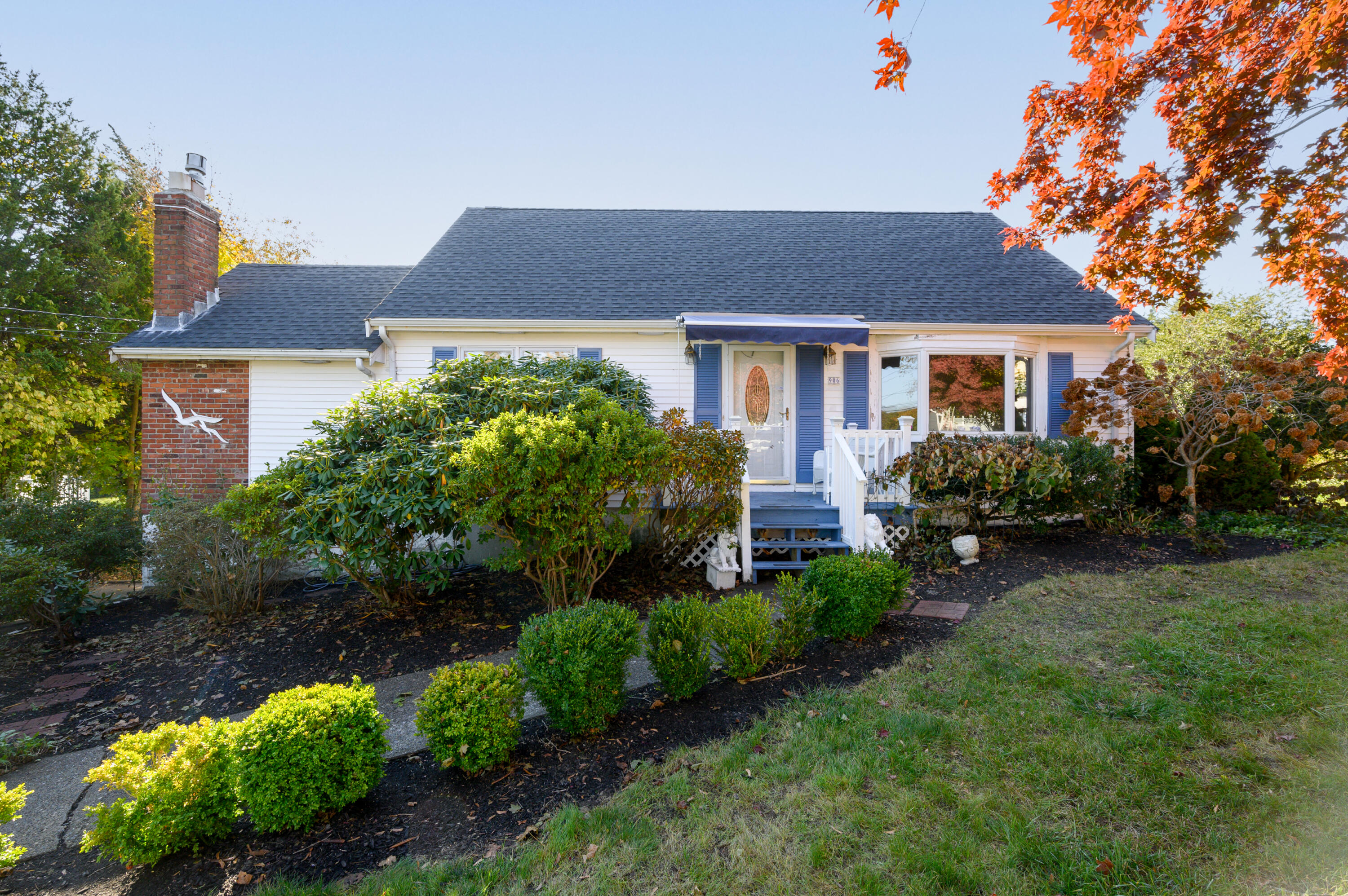 906 Shore Road Pocasset, MA 02559 - Photo 2 of 38 front view of a house with a yard