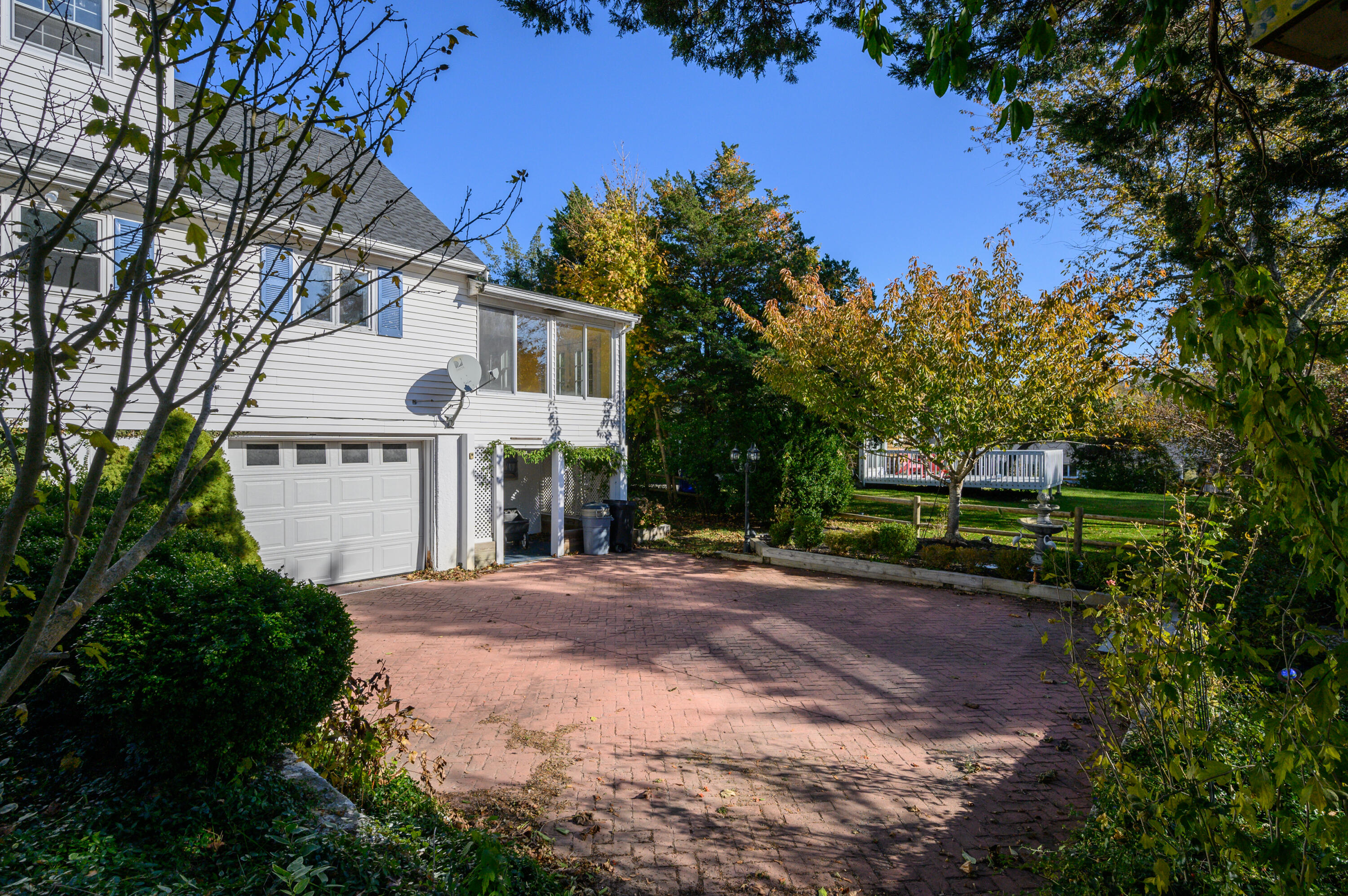 906 Shore Road Pocasset, MA 02559 - Photo 25 of 38 a front view of a house with a yard and garage