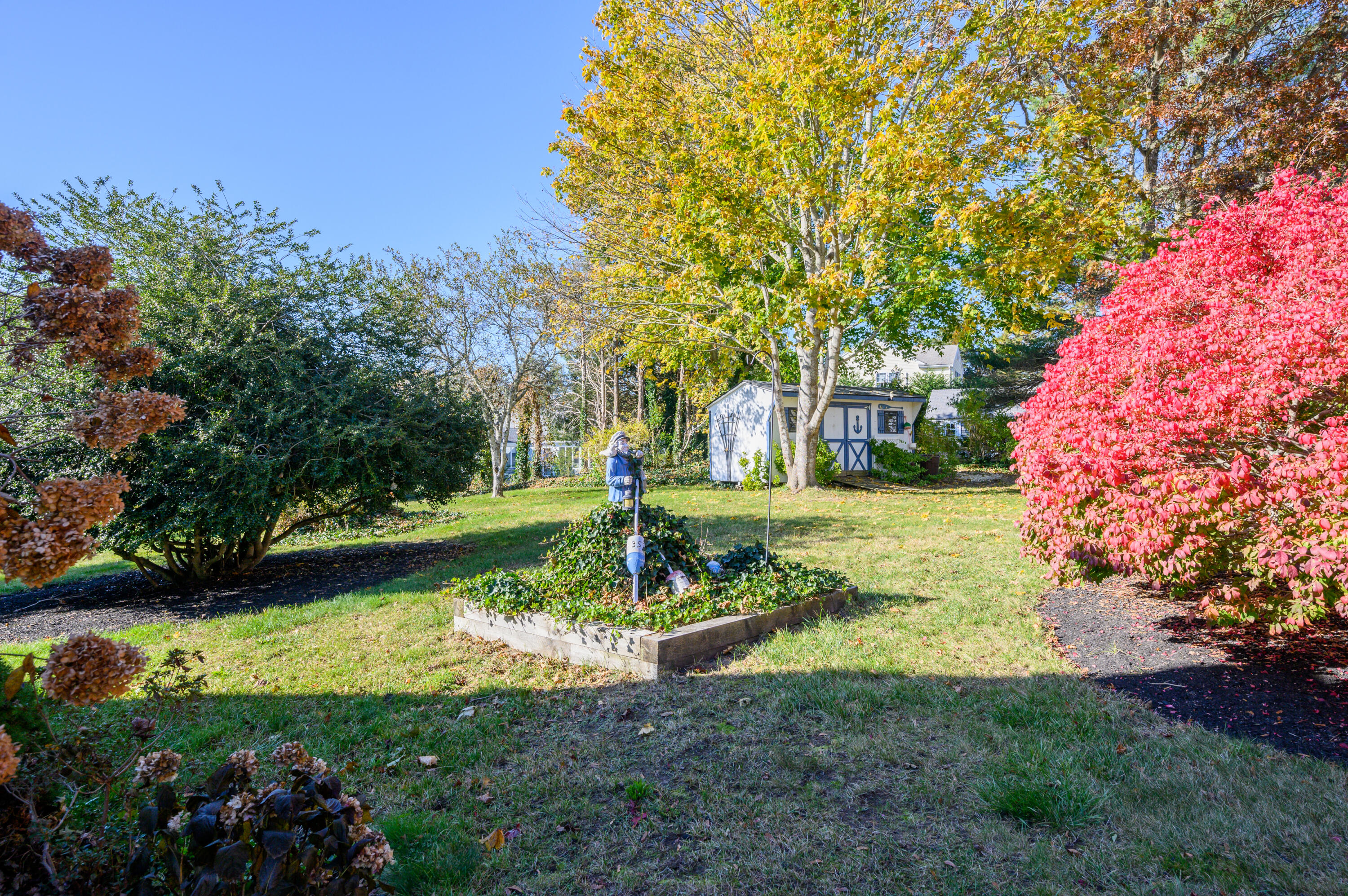 906 Shore Road Pocasset, MA 02559 - Photo 26 of 38 a view of a garden with large trees