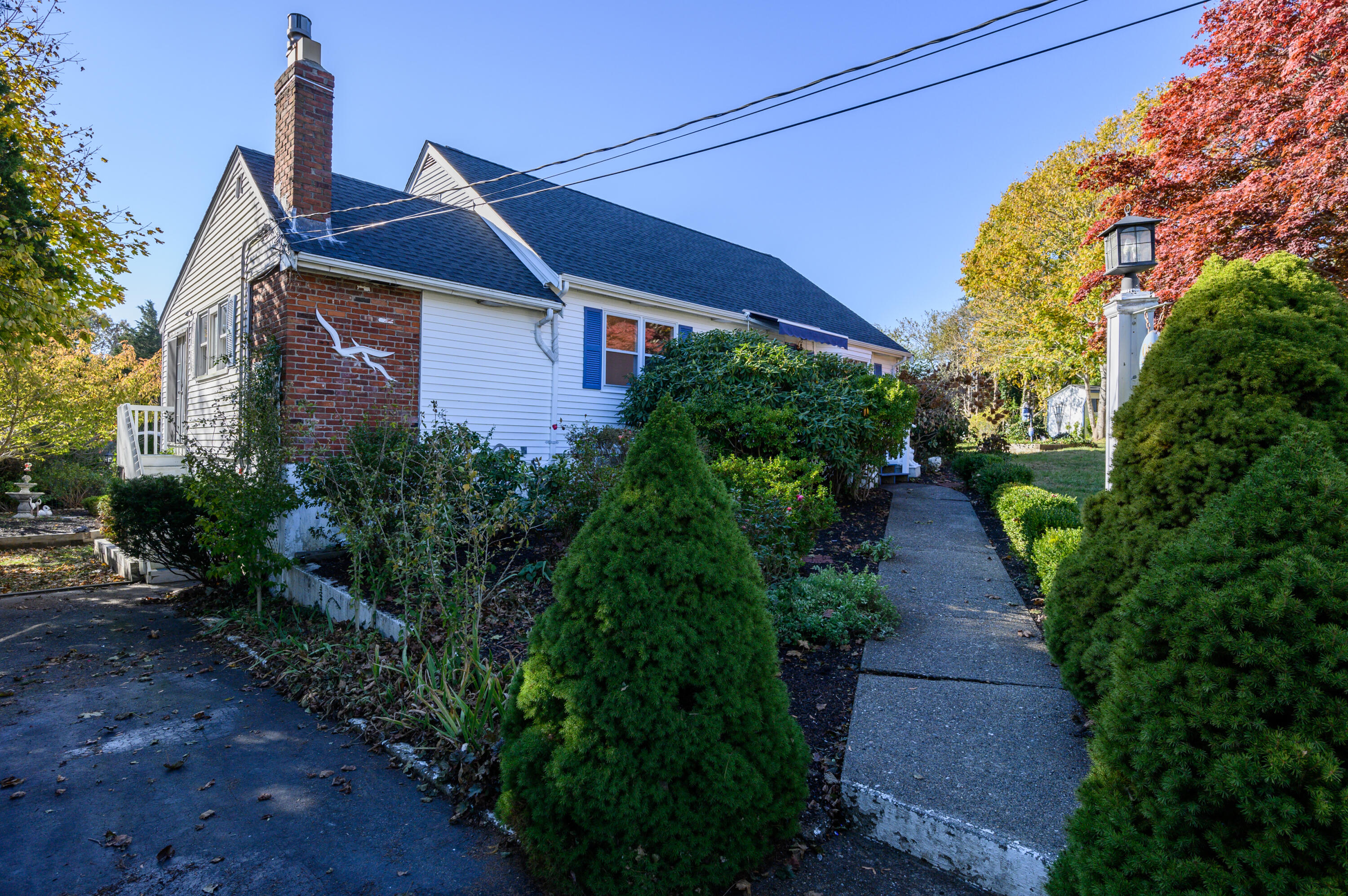 906 Shore Road Pocasset, MA 02559 - Photo 27 of 38 a front view of a house with a yard