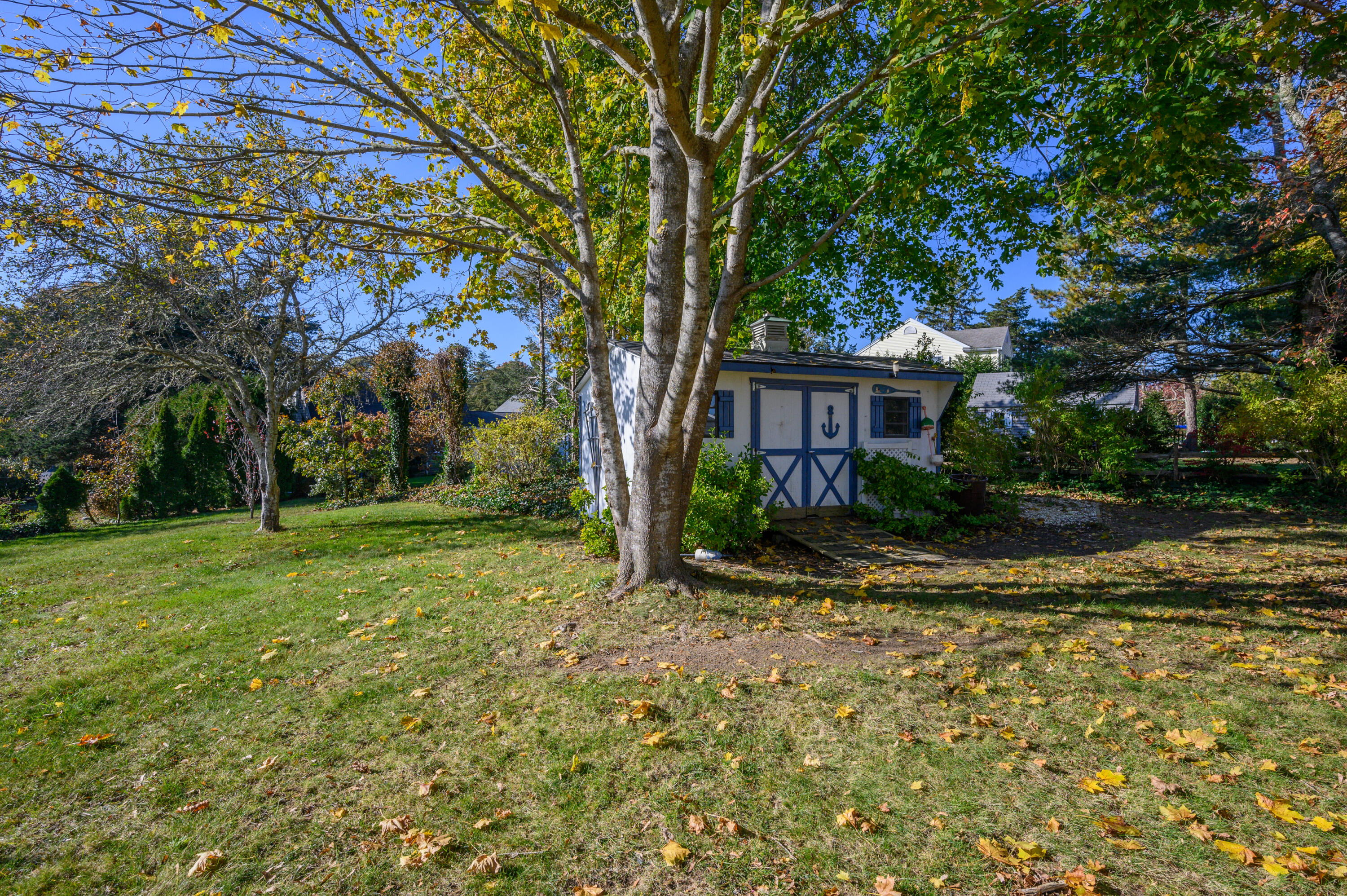 906 Shore Road Pocasset, MA 02559 - Photo 3 of 38 a view of a house with backyard and trees